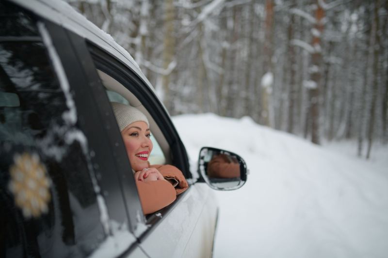 A neighbor in a car on a snowy day, about to head out