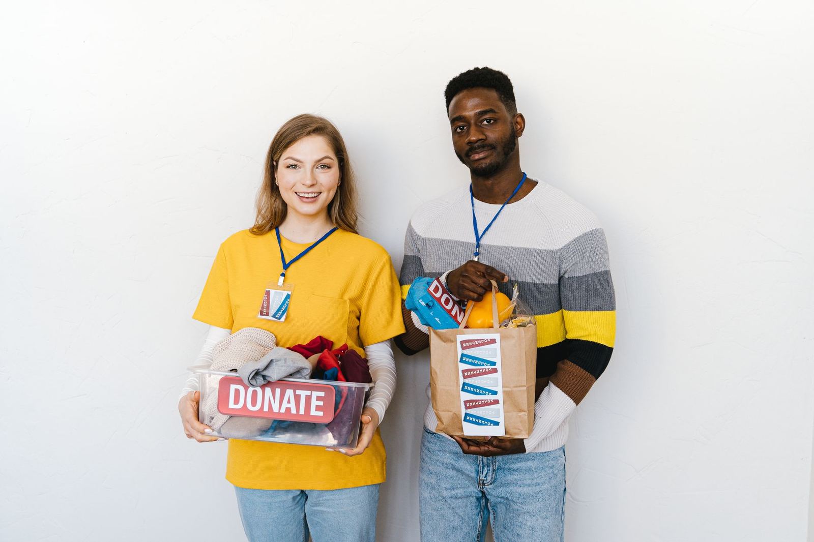 Two neighbors carrying bags of donations