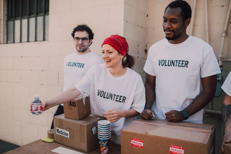 A team of volunteers working together at a donation table